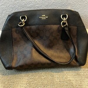 Coach bag, cross body and over shoulder straps. Two zipper compartments,